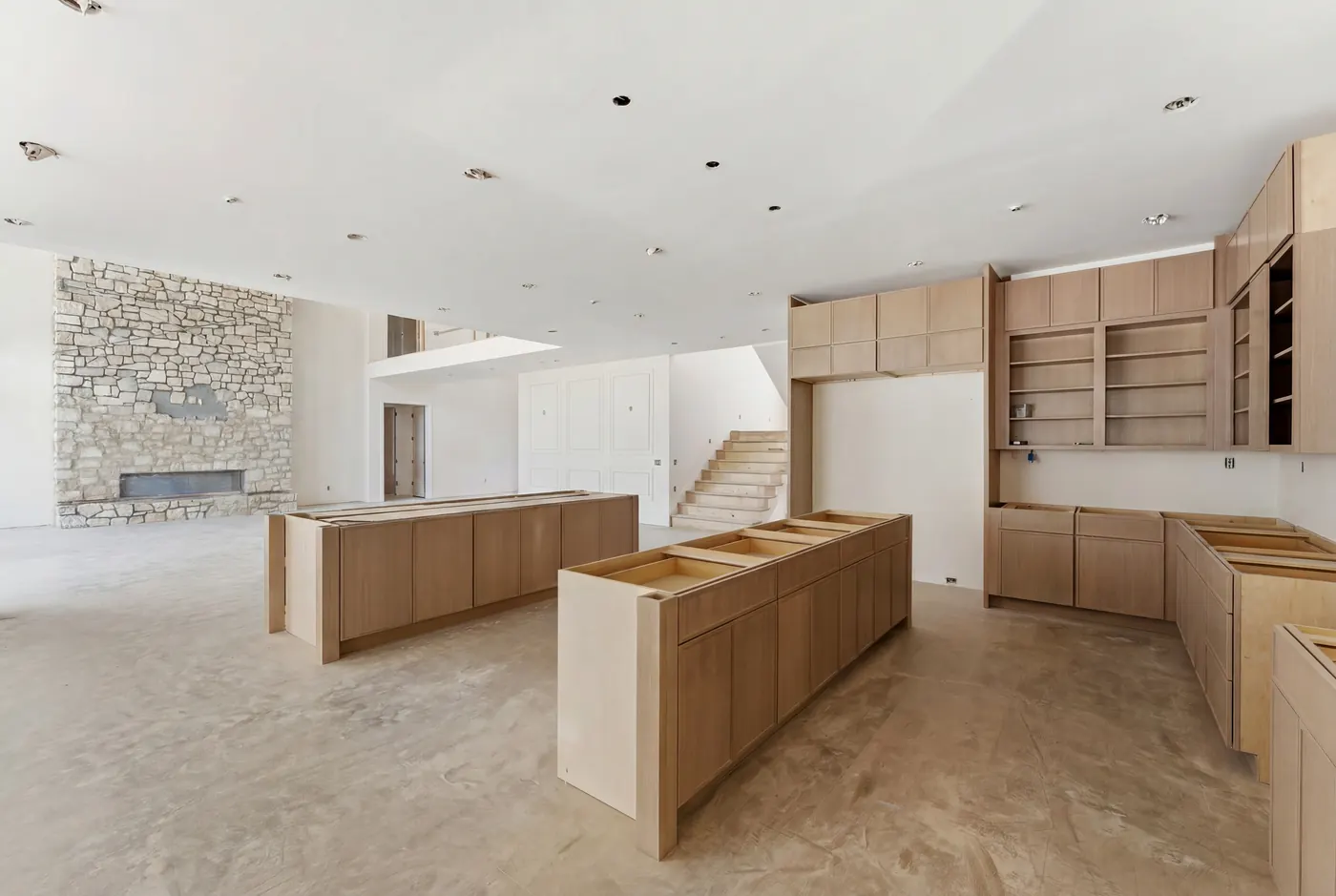 Kitchen with island beside a stone hearth