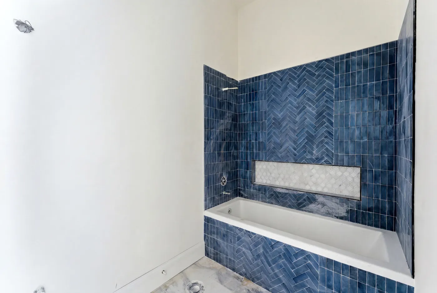 Spa bath with herringbone-tiled soaking tub