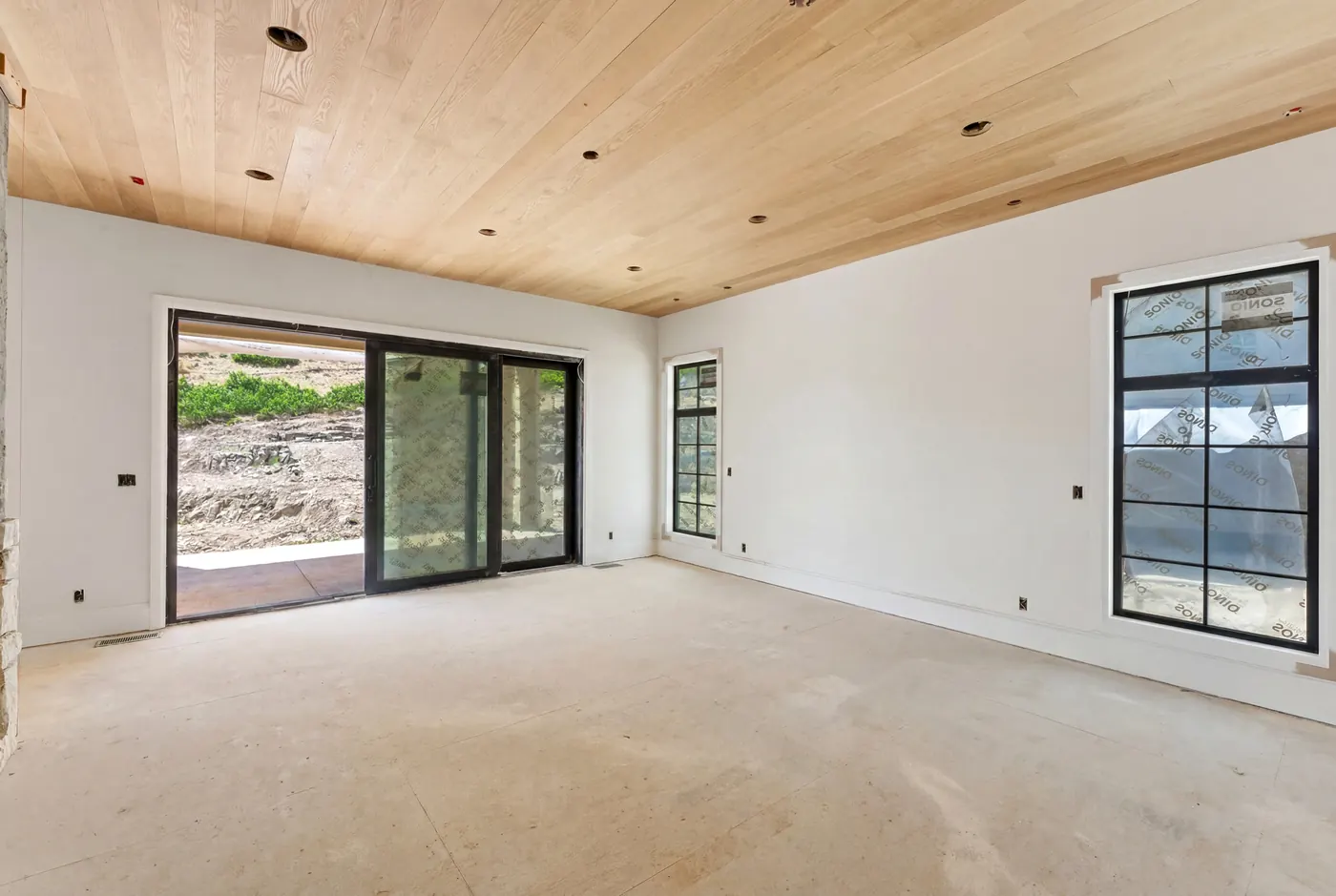 Living space with wood-beamed ceiling and sliding glass doors